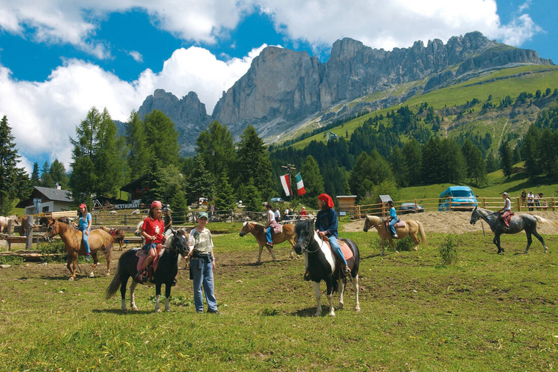 Pony Riding at the Carezza Pass with Red Wall