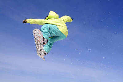 Snowboarder jumps